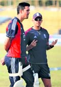 England�s coach Andy Flower (R) instructs Kevin Pietersen during a practice session in Chittagong on Wednesday