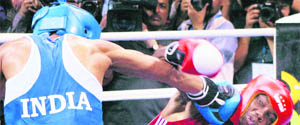 Jai Bhagwan (L) punches Valention Knowles of Bahrain in New Delhi on Wednesday.