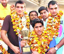Boxers Dinesh Kumar (L), Vijender (C) and Jai Bhagwan, who won gold medals at the Commonwealth Championships in New Delhi, during a function in Bhiwani on Thursday. 