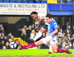 Chelsea�s Didier Drogba fights past Steve Finnan to score a goal against Portsmouth on Wednesday. 
