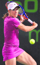 Justine Henin returns a shot against Vera Zvonareva during day seven of the 2010 Sony Ericsson Open in Florida