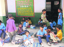 Students in a school in the heart of Bathinda town sitting in the corridor for their class on Thursday. 