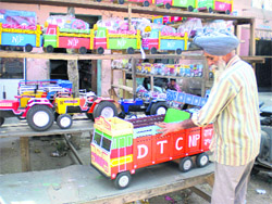 A carpenter busy displaying wooden toys at his shop in Dhanaula. 
