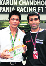 In a handout picture released by Hispania Racing F1 (HRT F1), Shahrukh Khan (L) with Karun Chandhok at the pit lane prior to the qualifying round for Malaysian GP in Sepang on Saturday.