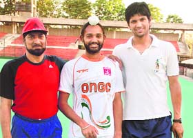 CHA coach Jasbir Singh Bajwa (L) with Preet Inder and Rupinder at the Sector 42 stadium in Chandigarh