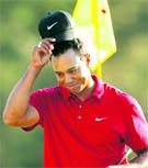 Tiger Woods tips his hat to the crowd after finishing his final round of play at the Augusta National Golf Club on Sunday. � Reuters