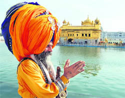 A Nihang pays obeisance in the Golden Temple