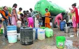 Residents await their turn to get water from a tanker in Chogitti, Jalandhar, on Tuesday. Tribune photo: Malkiat Singh