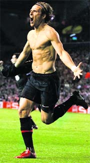 Diego Forlan celebrates his goal against Liverpool on Thursday.