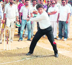 Jammu and Kashmir DGP Kuldeep Khodda plays the ceremonial shot during the Ashok Sodhi memorial cricket trophy in Jammu on Saturday.