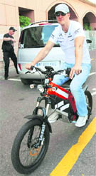 Michael Schumacher rides an hybrid bike as he arrives in the paddock prior to the start of the Monaco Formula One Grand Prix at the Monaco racetrack on Sunday