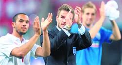 Theo Walcott and David Beckham applaud the crowd after the game on Monday.