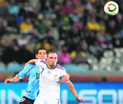 France�s Frank Ribery (R) fights for the ball with Maximiliano Pereira of Uruguay on Friday.