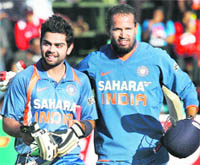 Virat Kohli (L) and Yusuf Pathan walk back after the T20 match against Zimbabwe in Harare on Saturday.