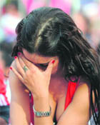 A Paraguayan woman reacts as Italy score the equaliser in Cape Town on Monday