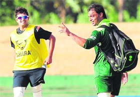 Pakistan�s Shoaib Akhtar (R) gestures as India�s Suresh Raina looks on during a training session in Dambulla