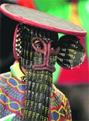 A Cameroon fan wears a face mask during the game between Cameroon and Denmark in Pretoria on Saturday.