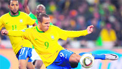 Brazil�s striker Luis Fabiano (R) shoots and scores during their match against Ivory Coast in Johannesburg on Sunday.