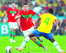 Portugal�s striker Cristiano Ronaldo (L) fights for the ball with Brazil�s defender Juan during their World Cup match in Durban