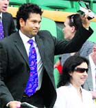 Sachin Tendulkar waves as he is introduced to the crowd on Centre Court at Wimbledon on Saturday.