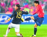 Chile�s midfielder Rodrigo Millar (R) scores against Spain as Spain�s defender Sergio Ramos looks on during their match in Pretoria on Friday