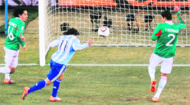 Argentina�s striker Tevez scores the opening goal against Mexico in Soweto on Sunday.