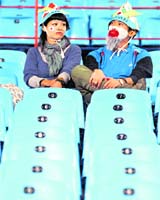 Two Japenese supporters wear a dejected look after their team lost out to Paraguay 5-3 in a penalty shootout
