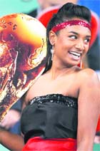 A German supporter holds a card replica of the World Cup trophy during the match between Germany and Spain in Durban on Wednesday.