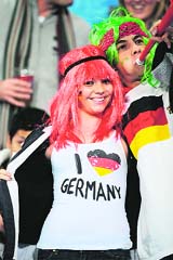 A German supporter cheers her team on during their third-place play off against Uruguay on Saturday