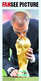 Italy�s Fabio Cannavaro kisses the World Cup trophy before the final between Netherlands and Spain in Johannesburg on Sunday. Italy had won the 2006 edition