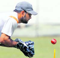 India captain MS Dhoni keeps wickets during a practice session on Monday