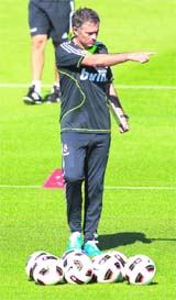 Real Madrid�s new coach Jose Mourinho, who calls himself the �Special One�, gives instructions to players during Real Madrid's training session in Madrid on Friday
