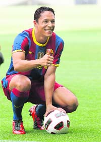 Barcelona's new player Adriano Correia gestures to photographers during his presentation at the Nou Camp stadium in Barcelona
