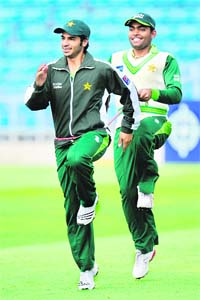 Pakistan's Salman Butt is held back by a rope by Umar Akmal (R) during a training session in Leeds