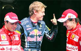 Red Bull Formula One driver Sebastian Vettel stands between second placed Ferrari�s Fernando Alonso (R) and third placed Ferrari�s Felipe Massa following the qualifying session for the German Grand Prix at the Hockenheim circuit on Saturday