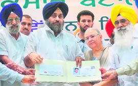 Deputy Chief Minister Sukhbir Singh Badal releases a special postal cover on the birth anniversary of Shiv Batalvi at Batala on Friday. Aruna Shiv Batalvi, wife of the poet, is also seen in the picture.
