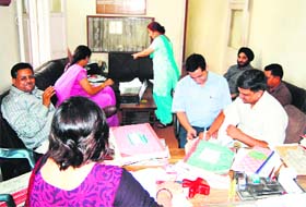 Officials of the CBI examine documents at Shri Laxmi Narayan Ayurvedic College in Amritsar
