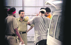 A police ambulance waits to take an injured jail inmate to hospital in Ludhiana