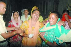 Relatives of the blast victims (right above) grieving over their loss; National Disaster Response Force personnel carrying out rescue operations at the site.