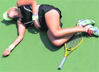 Victoria Azarenka lies on the court after she collapsed during her match against Gisela Dulko