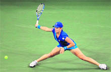 Kim Clijsters returns a shot against Vera Zvonareva during her women's singles final at the Flushing in New York City on Saturday. 