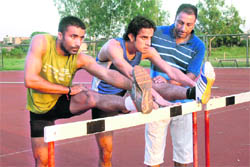 Harpreet Singh, Manjit Singh and their coach Sarabjit Singh during a training session. 