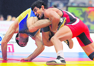 Sushil Kumar (red) fights for the gold with Russian Alan Gogaev during the 66 kg freestyle final at the World Wrestling Championship in Moscow on Sunday.