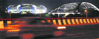The Indira Gandhi Indoor Stadium and the cycling velodrome are lit up as part of the test run before the start of the Commonwealth Games in New Delhi