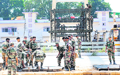 Indian Army soldiers prepare iron structures to reconstruct a collapsed overbridge outside Jawaharlal Nehru Stadium, the main CWG venue, in New Delhi on Sunday.