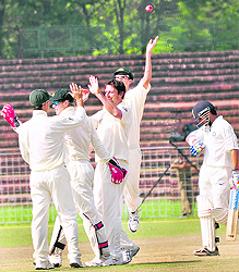 Australian players celebrate the wicket of Gautam Gambhir in Chandigarh on Sunday.