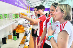 Athletes view merchandise at a store in the Village