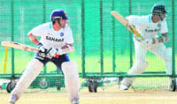 Sachin Tendulkar (L) and VVS Laxman bat in the nets at the Sector 16 Stadium in Chandigarh 