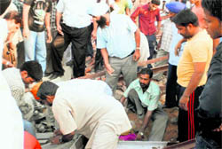 Residents try to rescue injured persons from the debris of the collapsed shed of a mill in Jodhan village, near Ludhiana, on Friday