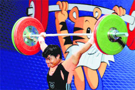 Renu Bala completes a lift  to win gold in the women's 58kg category.